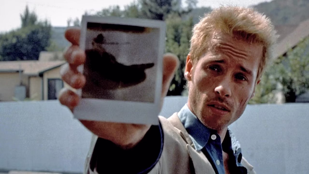 Leonard shows a Polaroid photo
